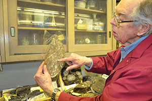 Prof. Emeritus Tom Phillips in the lab inspecting a fossil
